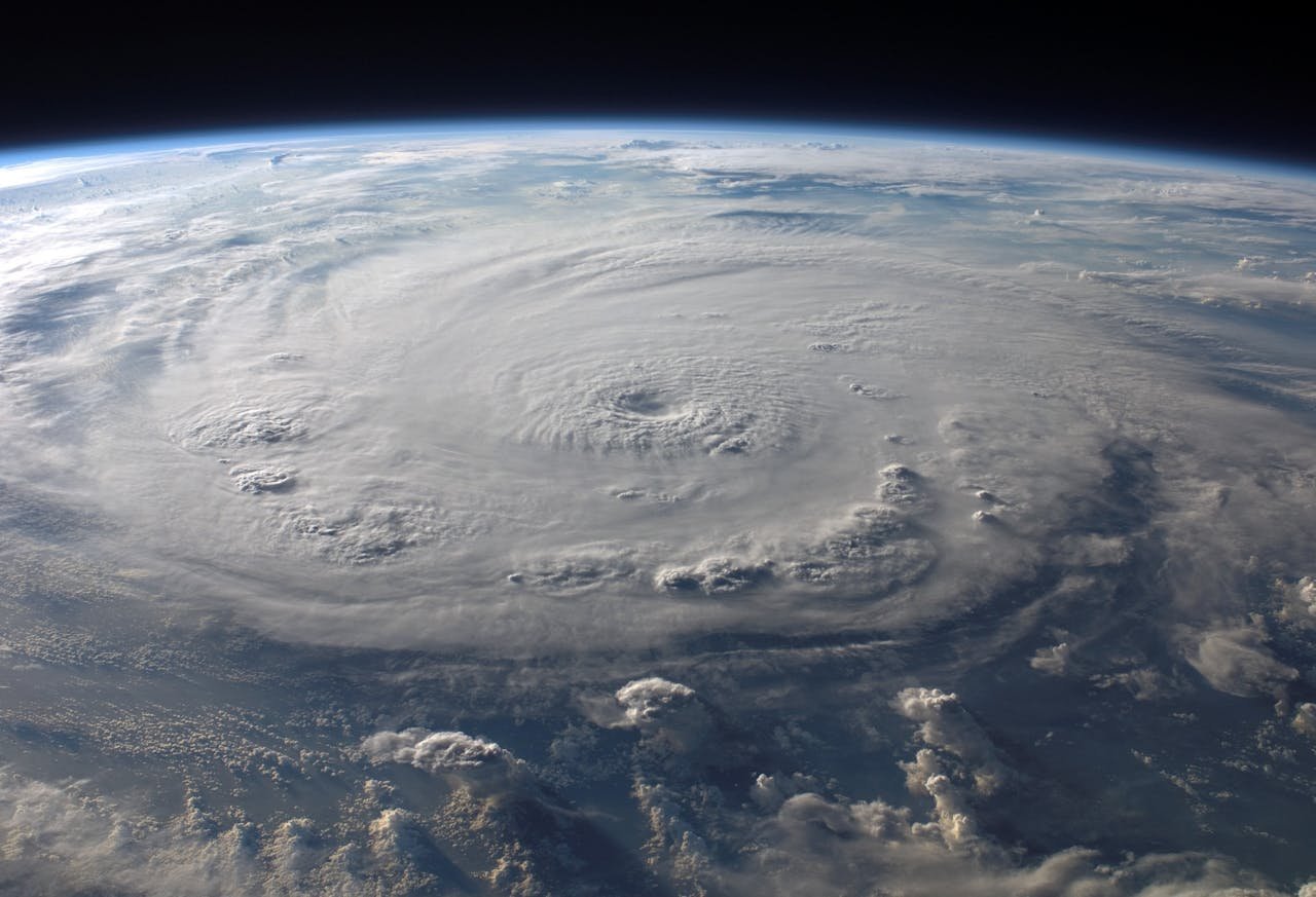 journey A stunning aerial view of Earth with a massive swirling hurricane, highlighting meteorological beauty.