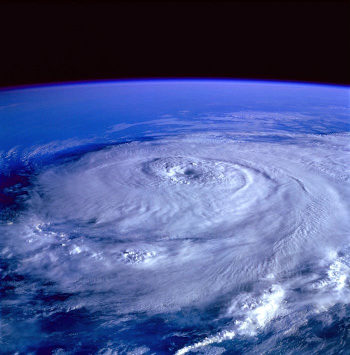 services-02 A breathtaking satellite image capturing a swirling hurricane over the Earth's ocean.
